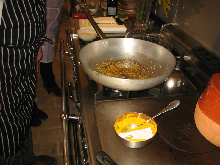 a frying pan full of food near a sink