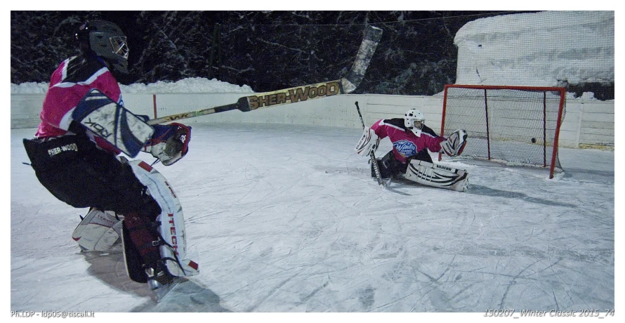 the person is holding their sled in front of a goalie