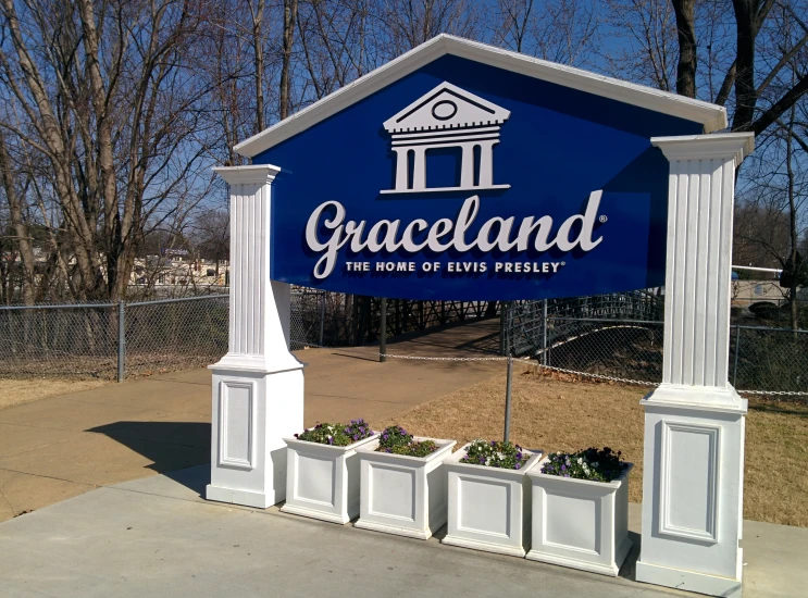 the graceland sign is next to two flowers