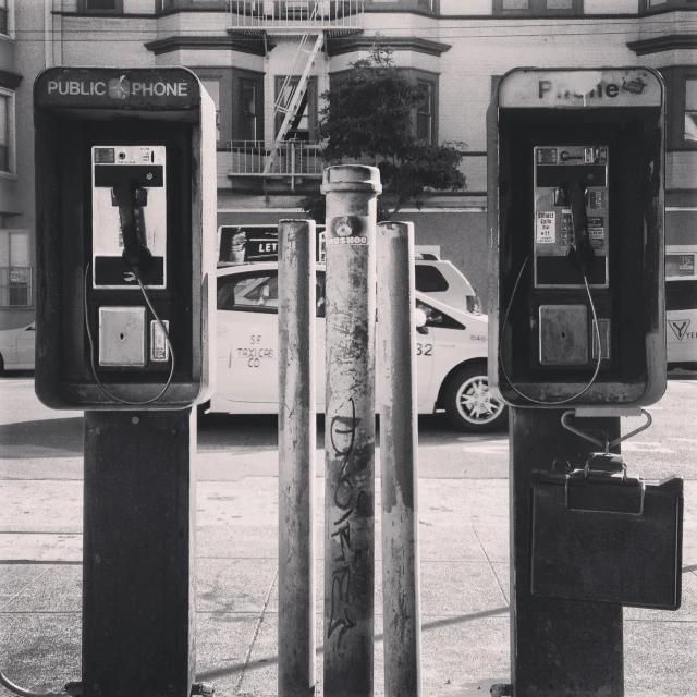 two machines and a phone on a street