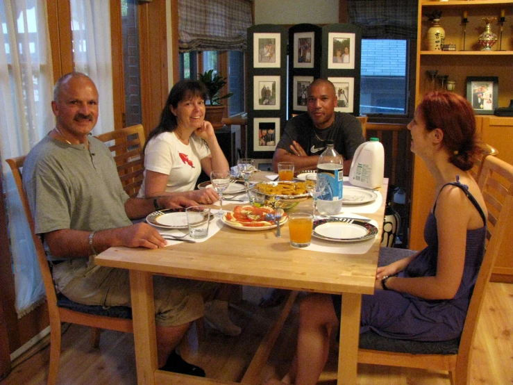 four people at a table having a meal