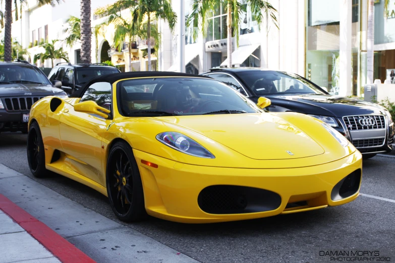 a very nice yellow sports car on the road