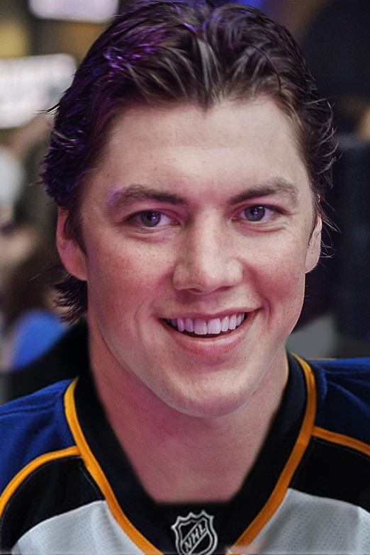 the hockey player smiles in front of the camera