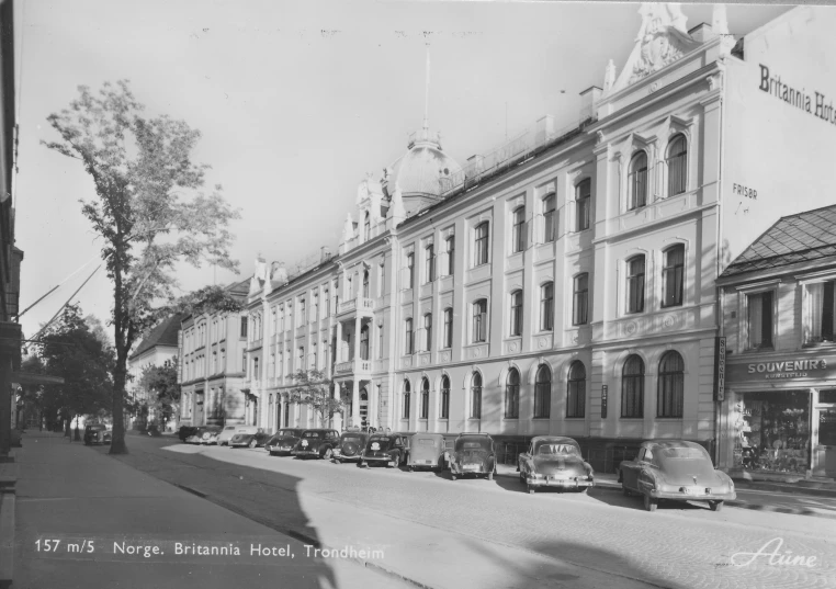 old po of cars parked on the street in front of old buildings