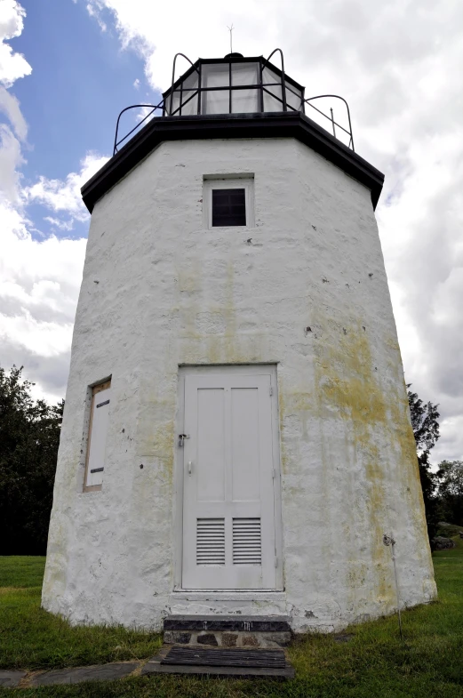 a large light house in the middle of the field