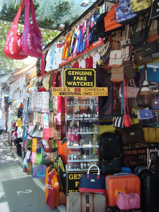 there are many handbags and purses that are hanging on the shelves