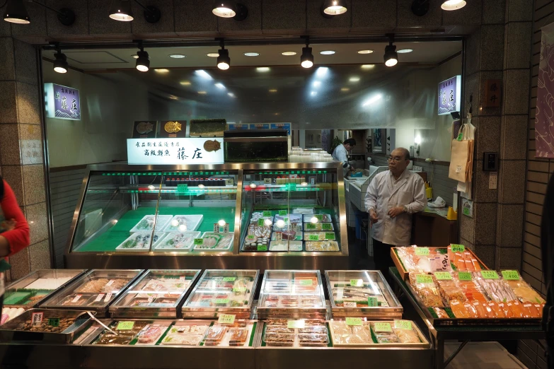 a fish market with glass display cases full of fish