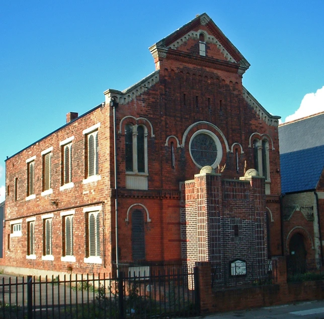 a large church building sits in the middle of an empty street