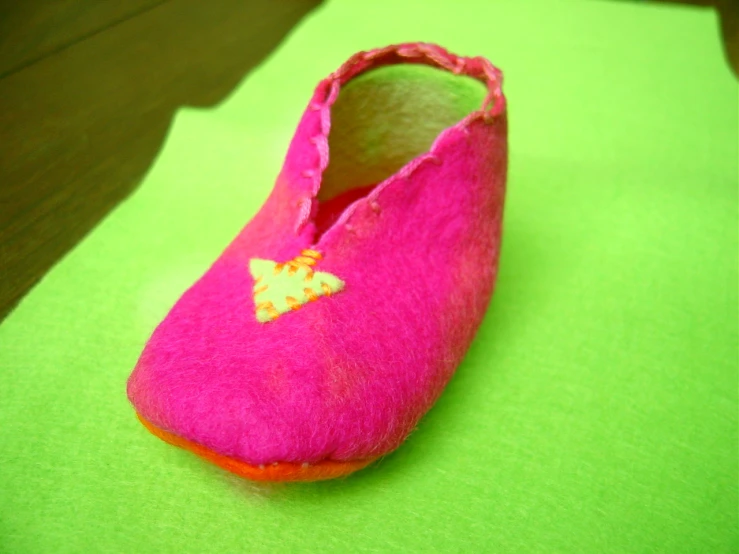 the pink shoes have an embroidered yellow erfly