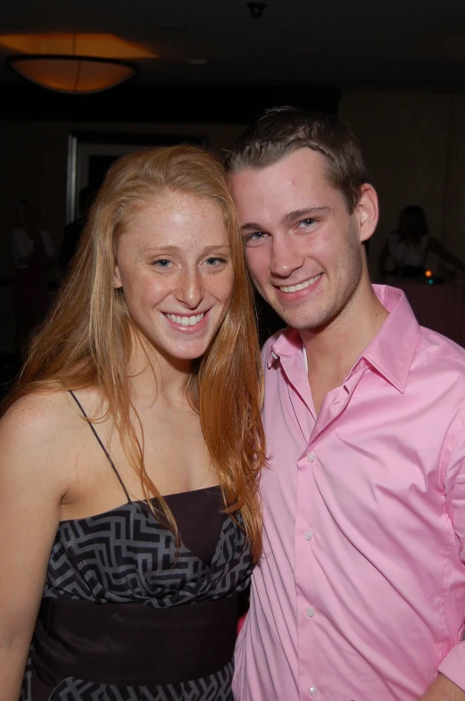 a man and woman smiling next to each other