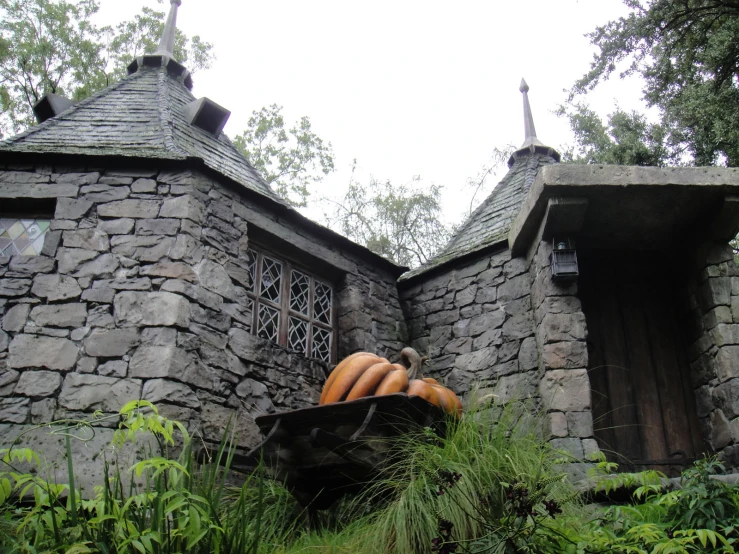 an old building with some very big pumpkins