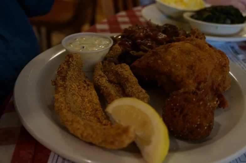 fried chicken with other dishes in bowls on the side