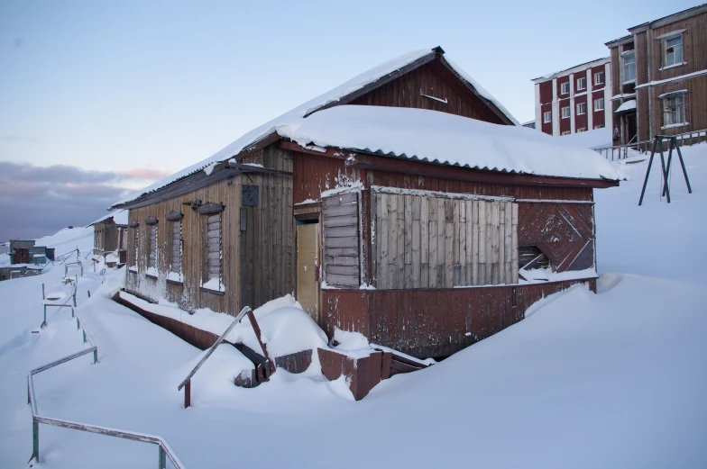 a small building sitting on top of snow covered ground