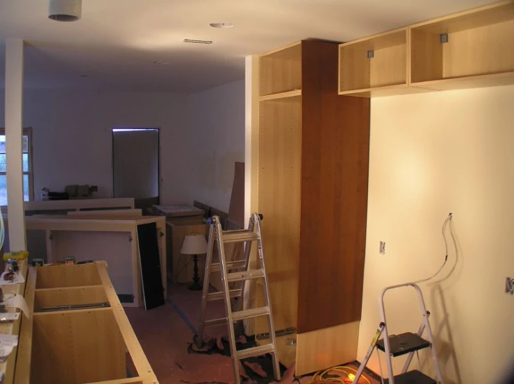 a kitchen being remodeled with an extension ladder