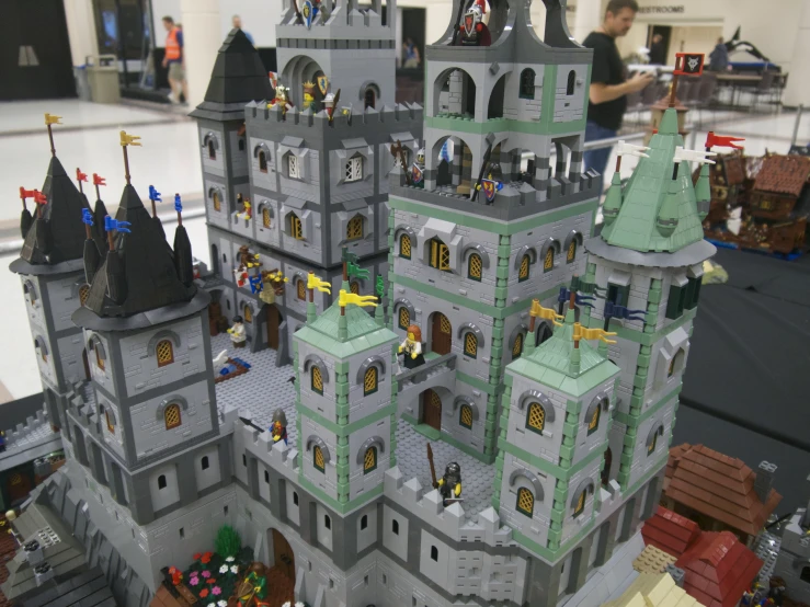 a grey and green castle is shown with a table