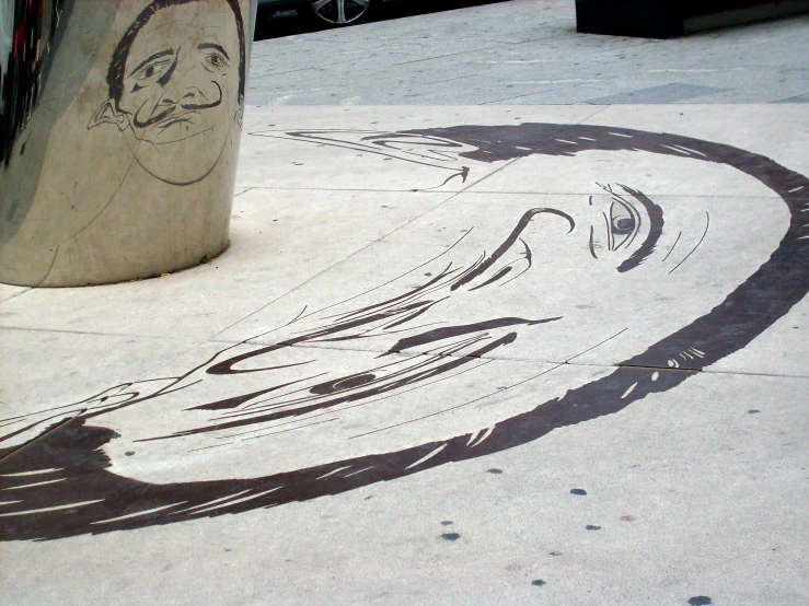 a drawing is shown on the sidewalk of the city
