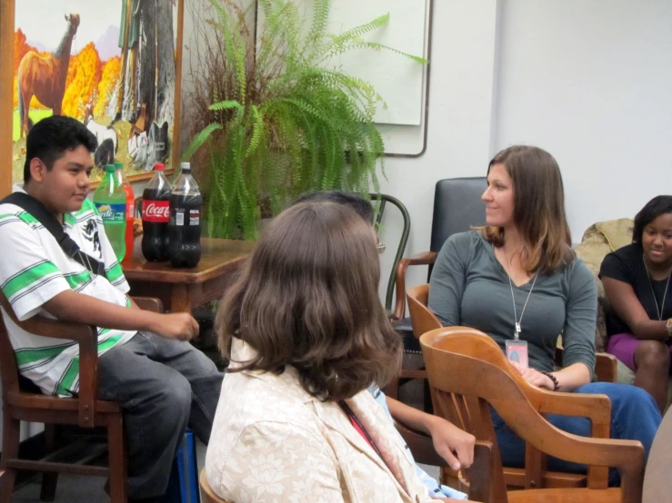 there are four people sitting around the table together