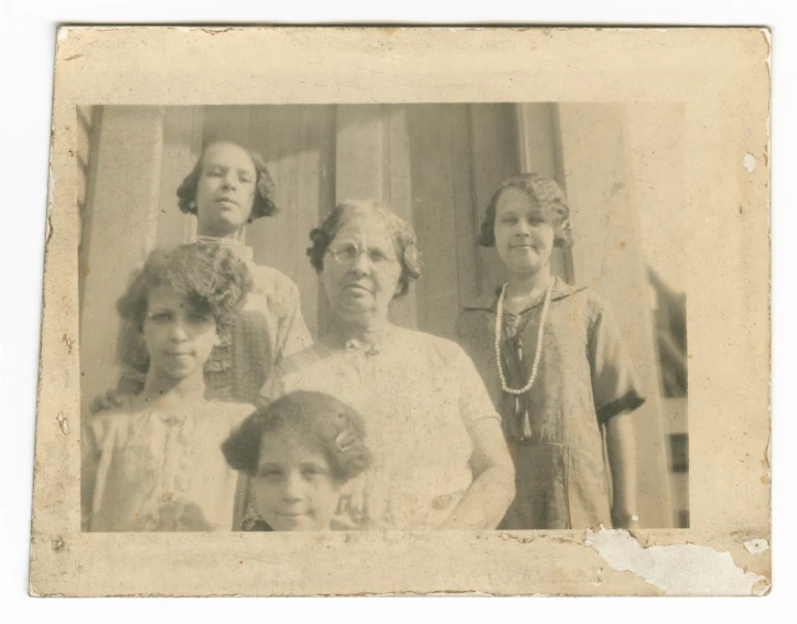 an old fashion picture shows the four women in dresses