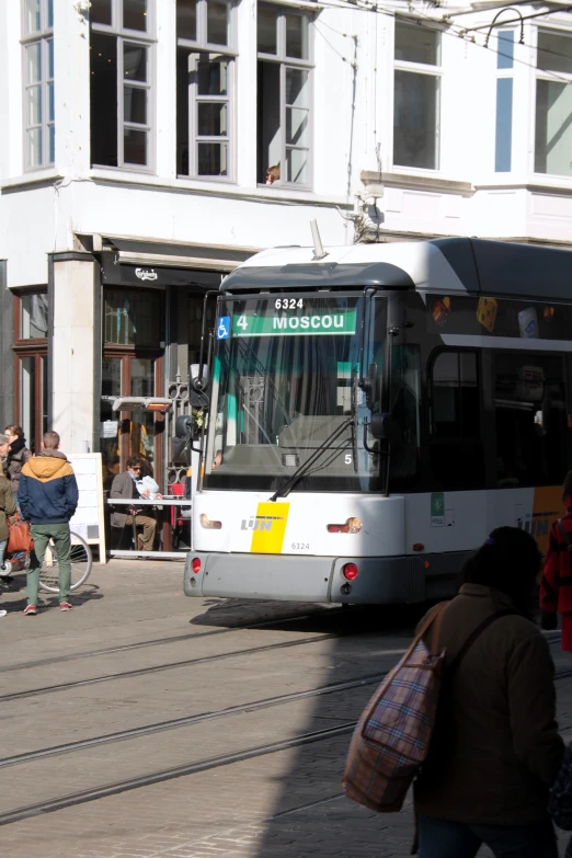 a public transit bus parked on the side of the road