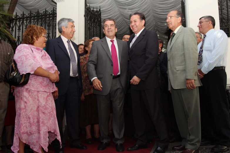 three men and a woman stand in a group