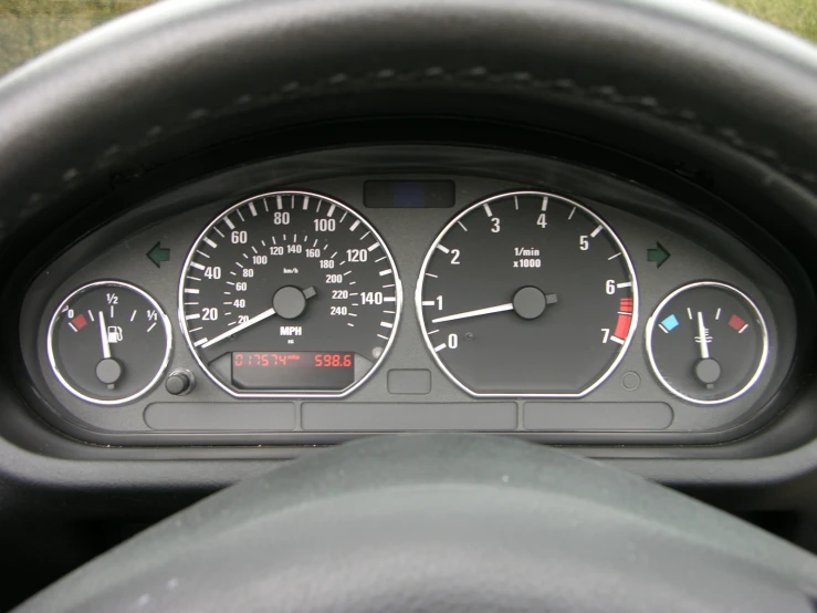 a car dashboard showing two different gauges, two on and one on the ground