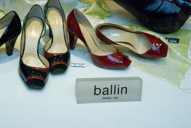 three pairs of shoes on display on table