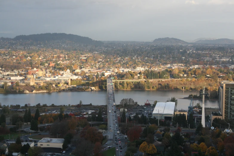 a city with several towers next to a large body of water