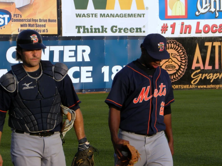 a man with baseball equipment stands in front of another man