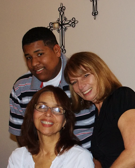 four people are standing together, smiling for the camera