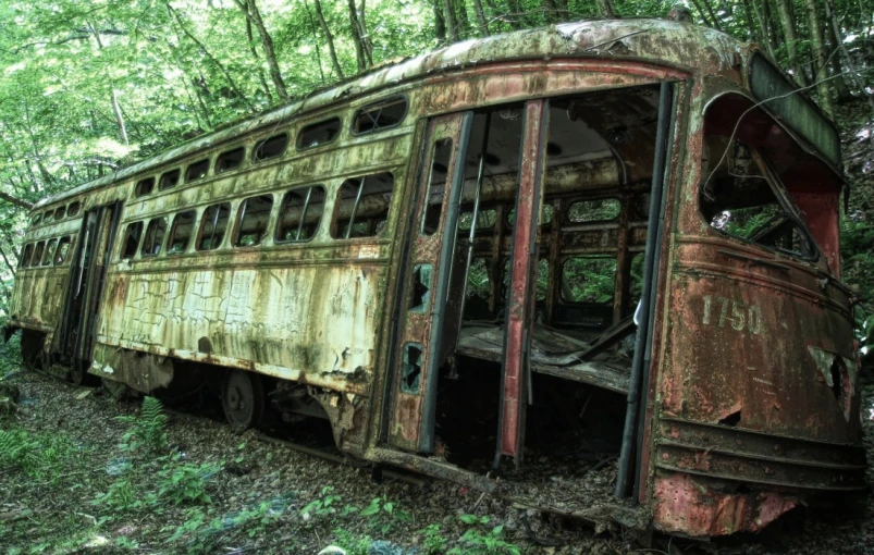 an old bus is parked in the woods