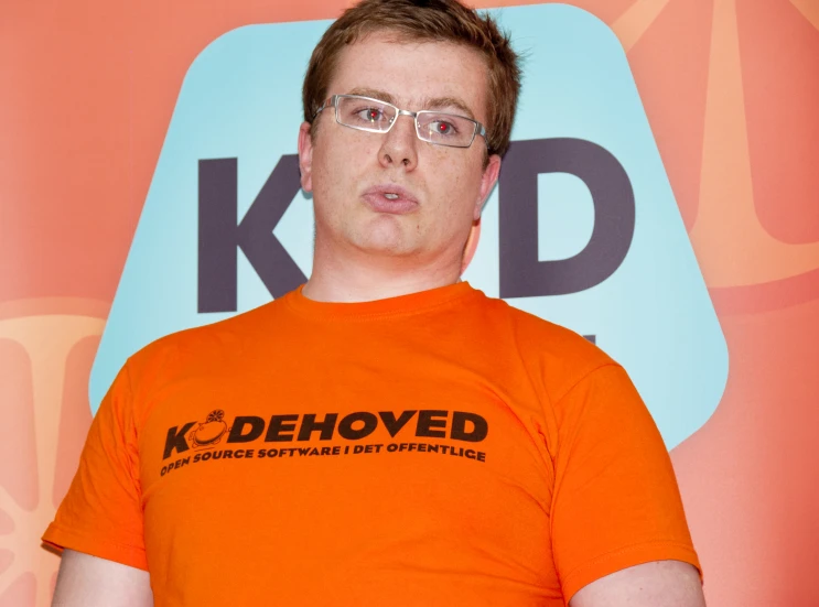 a man in an orange shirt holding an orange object