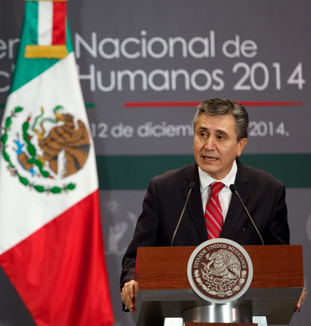 a man stands at a podium speaking