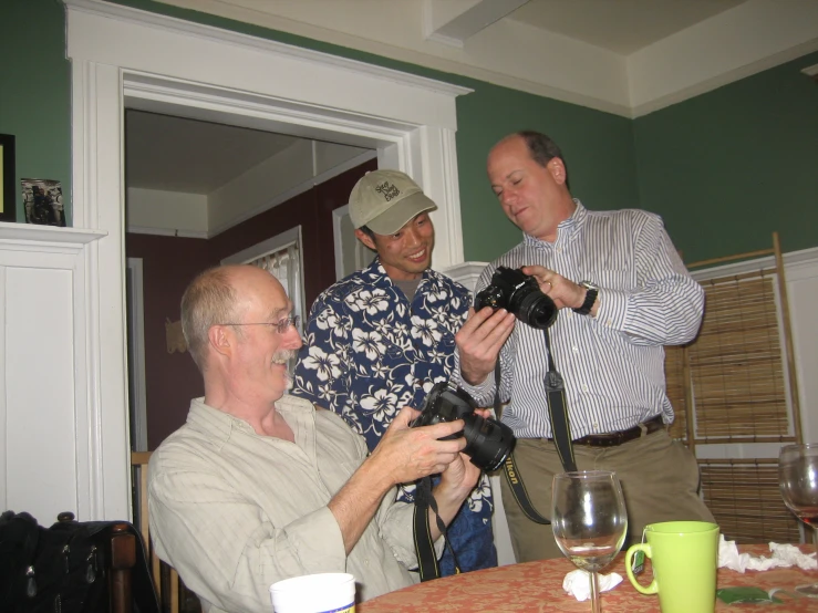 three men having fun together while one is getting his picture taken