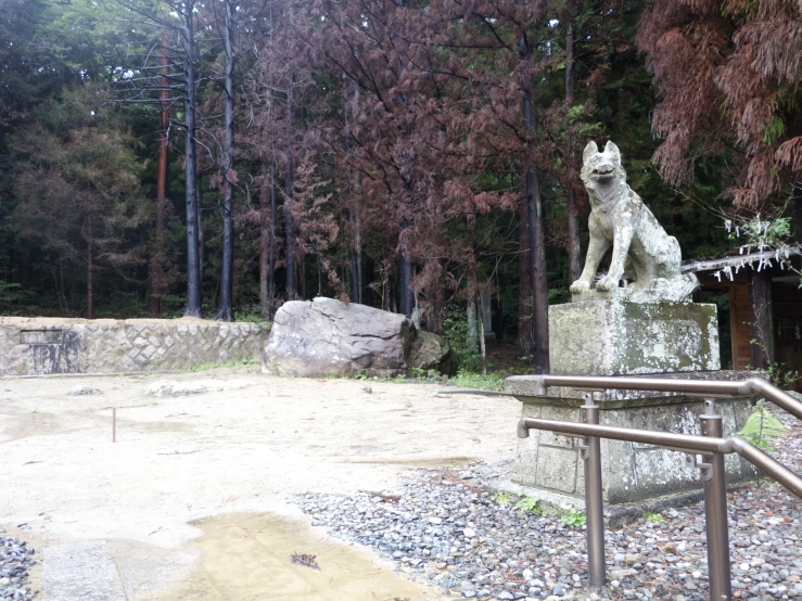 a dog statue is shown in the middle of a rocky field