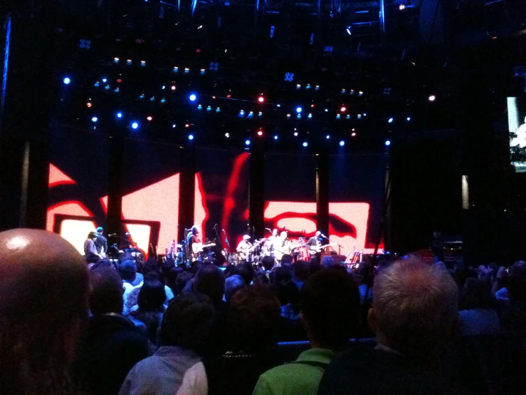 the concert is full of people watching a man perform on stage