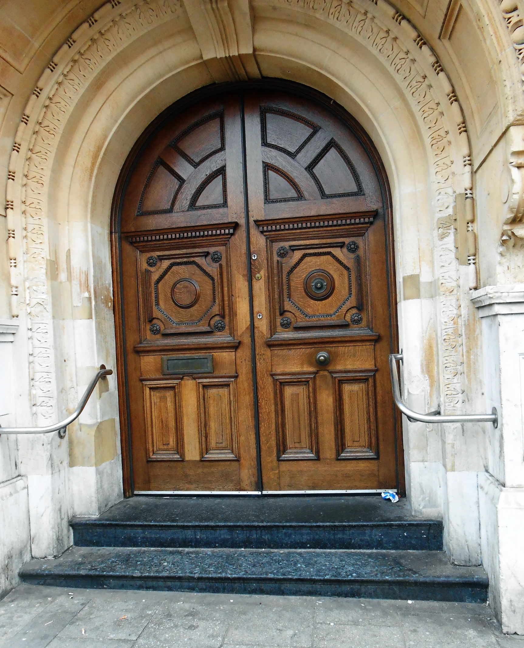 the entrance to an old building has double brown doors