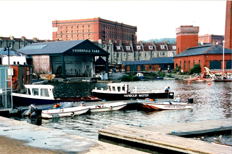 a city with large boats docked and buildings in the background