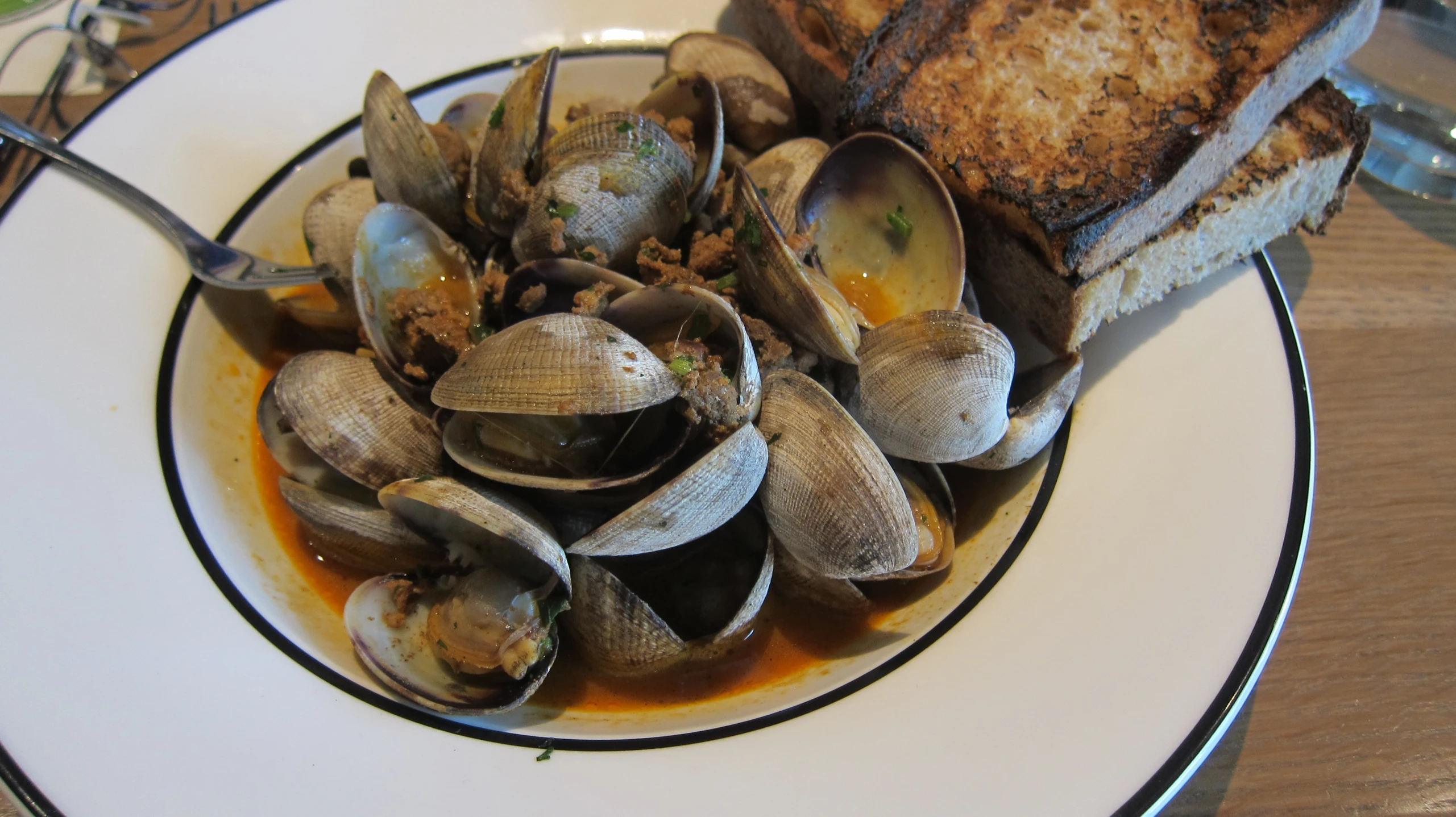 plate of food with clams on bread and sauce