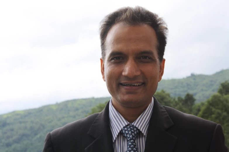 a man wearing a tie is posing for a picture