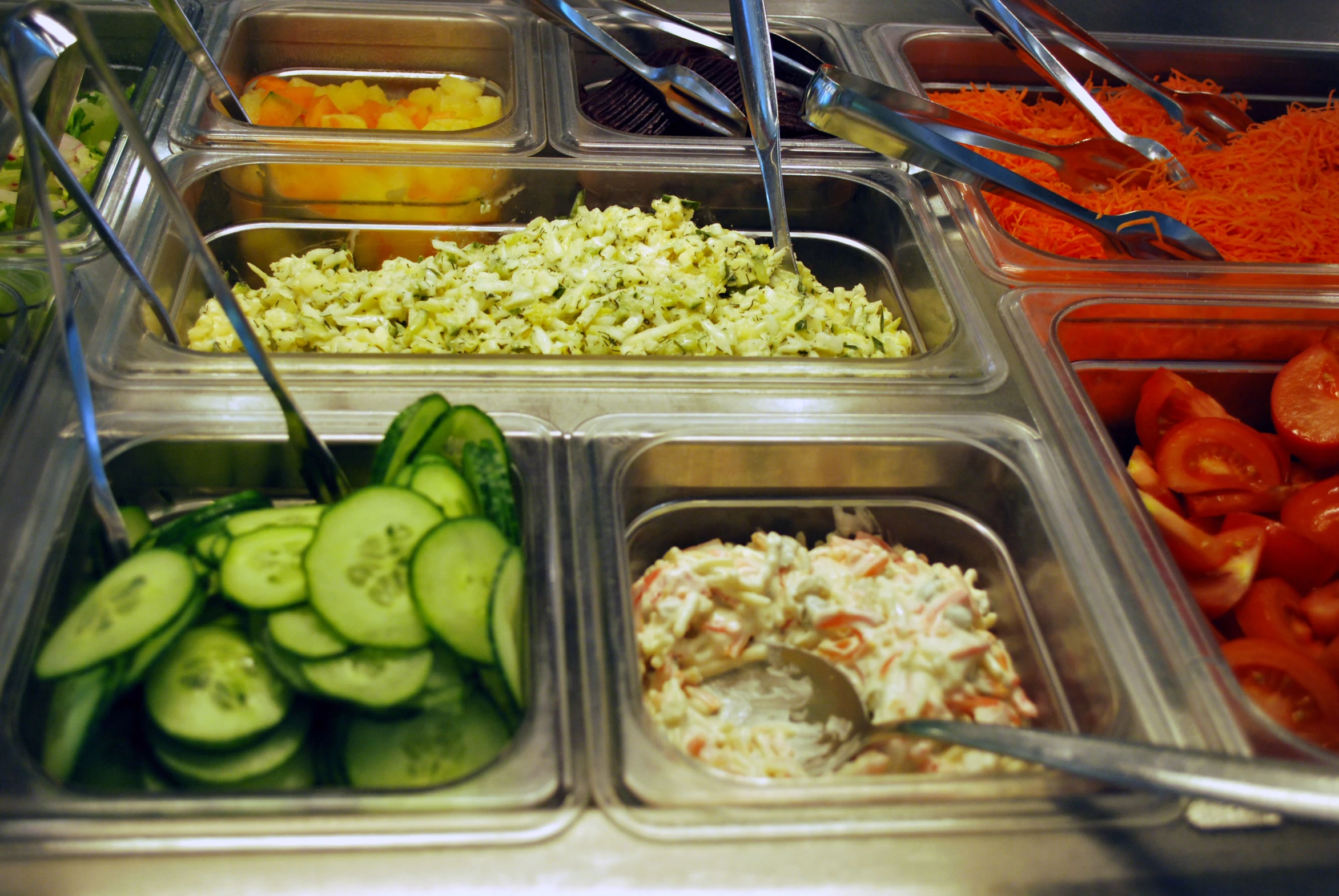 vegetables laid out on containers in the buffet