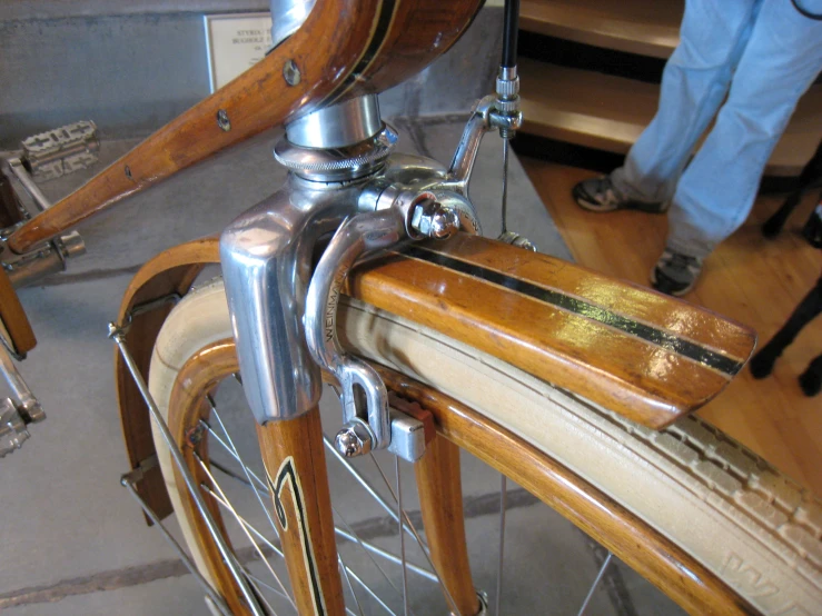 closeup of bike seat with a wooden bicycle handlebar