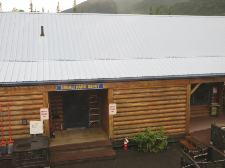 a log building with a loading dock near it