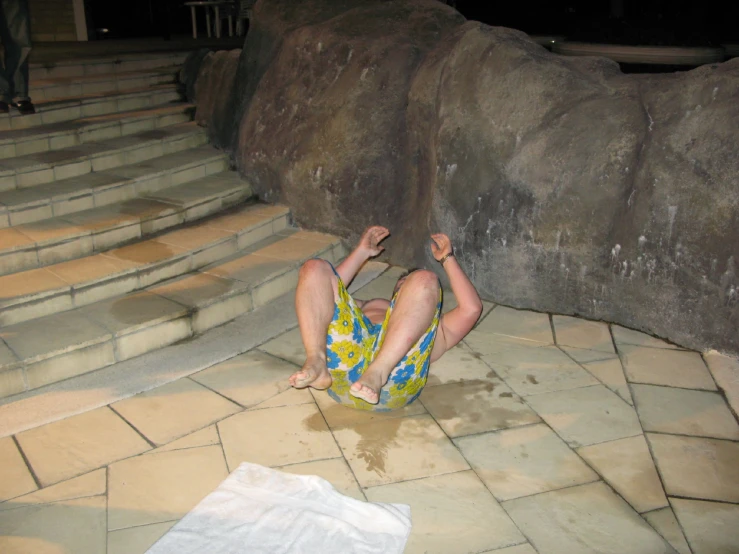 a boy dives into some water and plays with himself