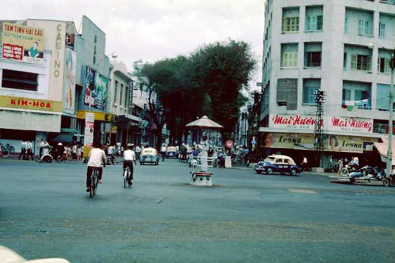 a group of people riding bikes down a city street