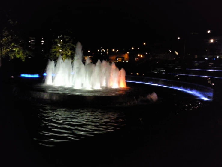 a fountain with multiple colored jets spewing from it