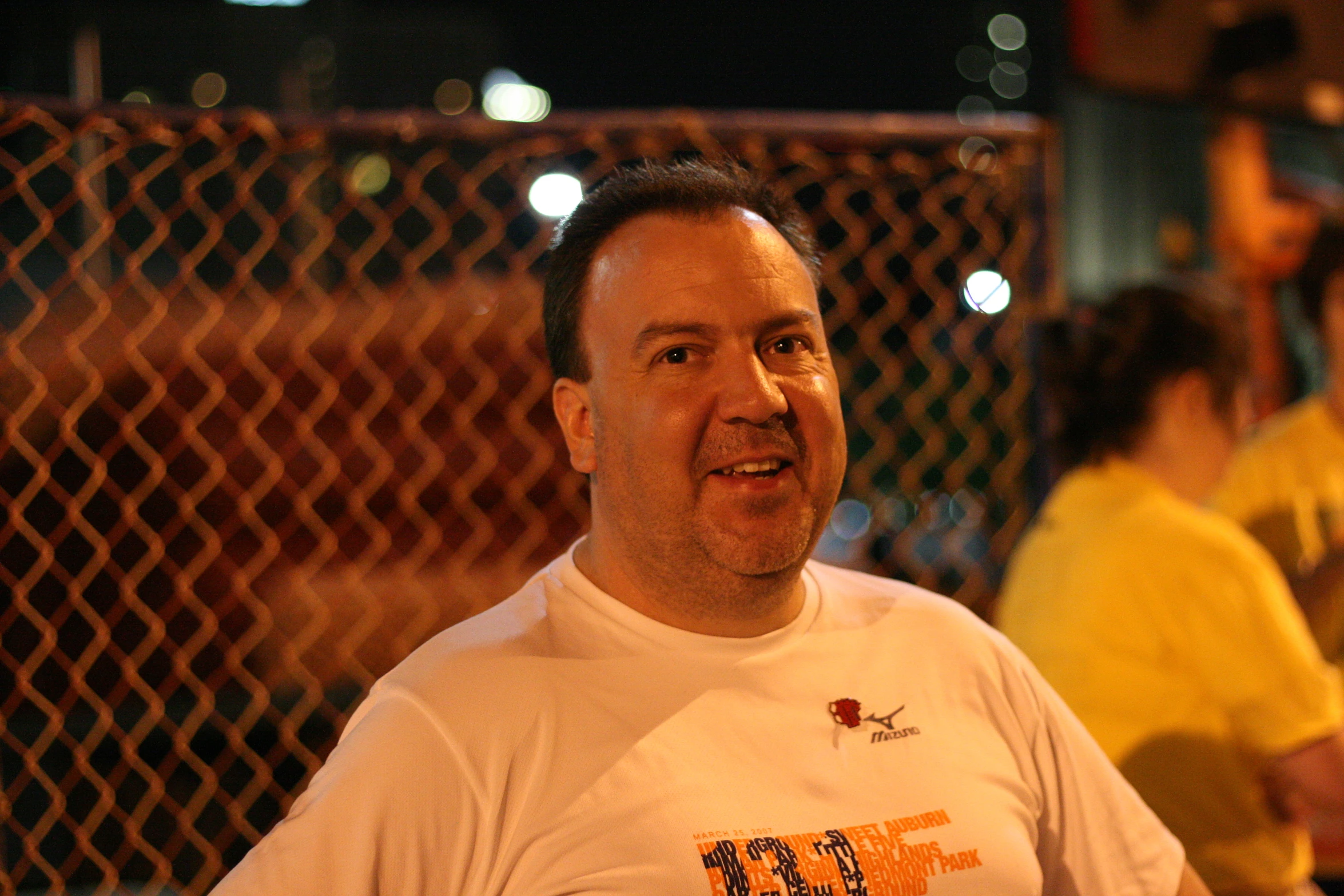 a man in a white shirt with a smile on his face