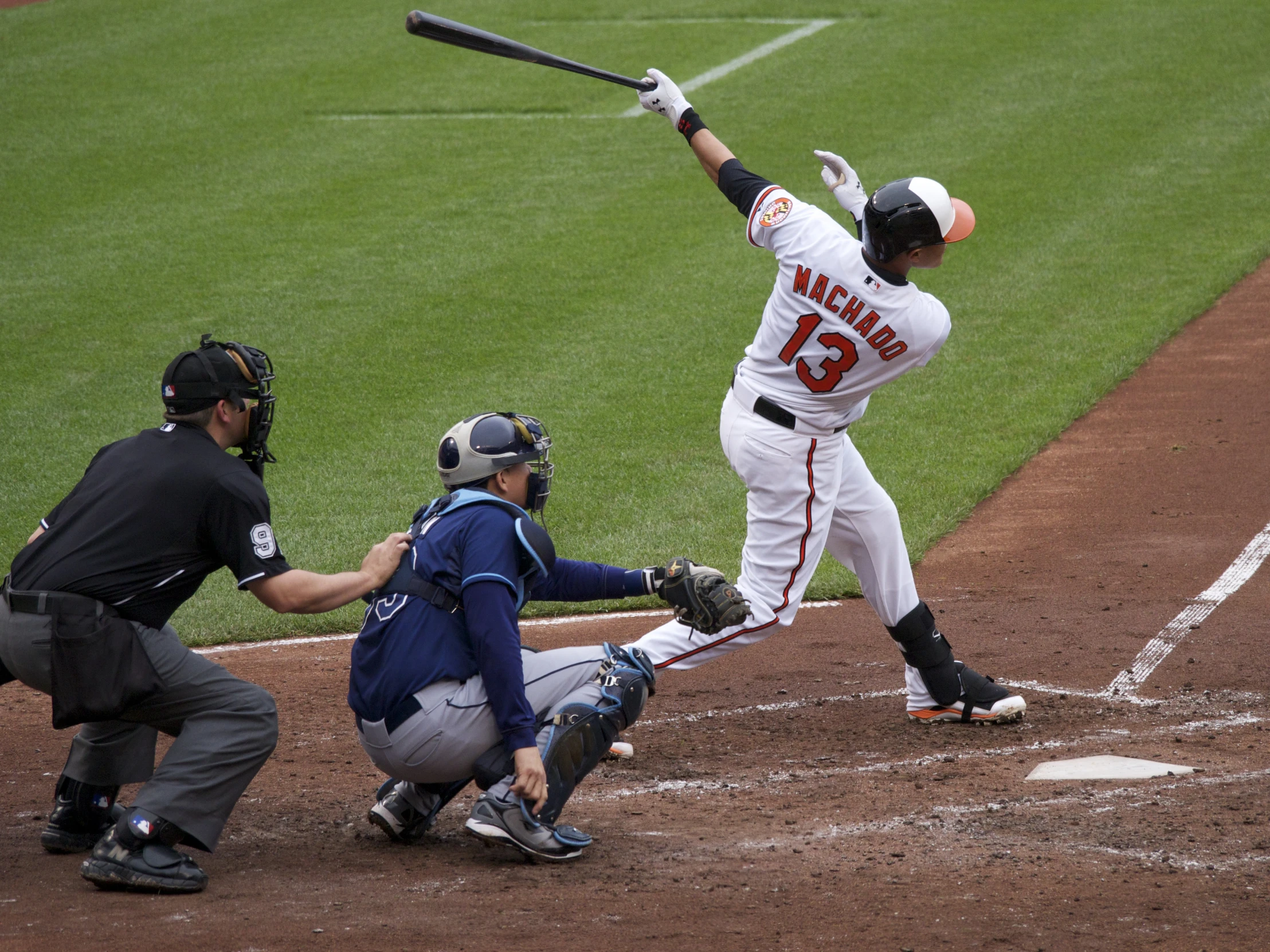 a baseball player is swinging a bat at a ball