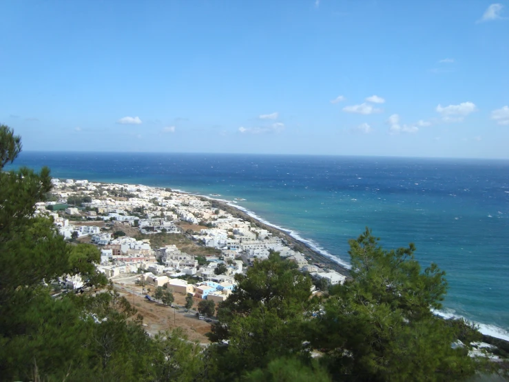 a scenic view of a beach from a hill
