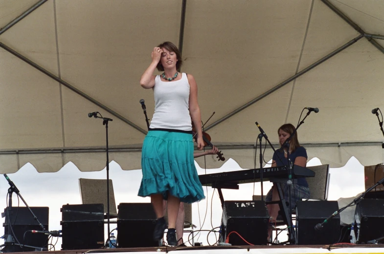 a woman is singing and holding a microphone