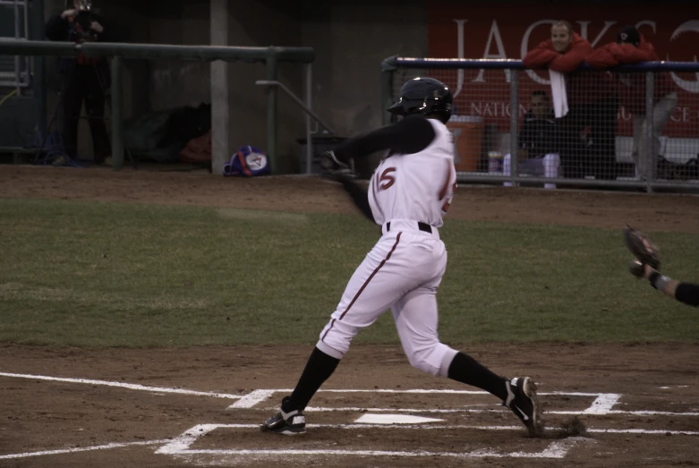 the baseball batter is swinging his bat in a game